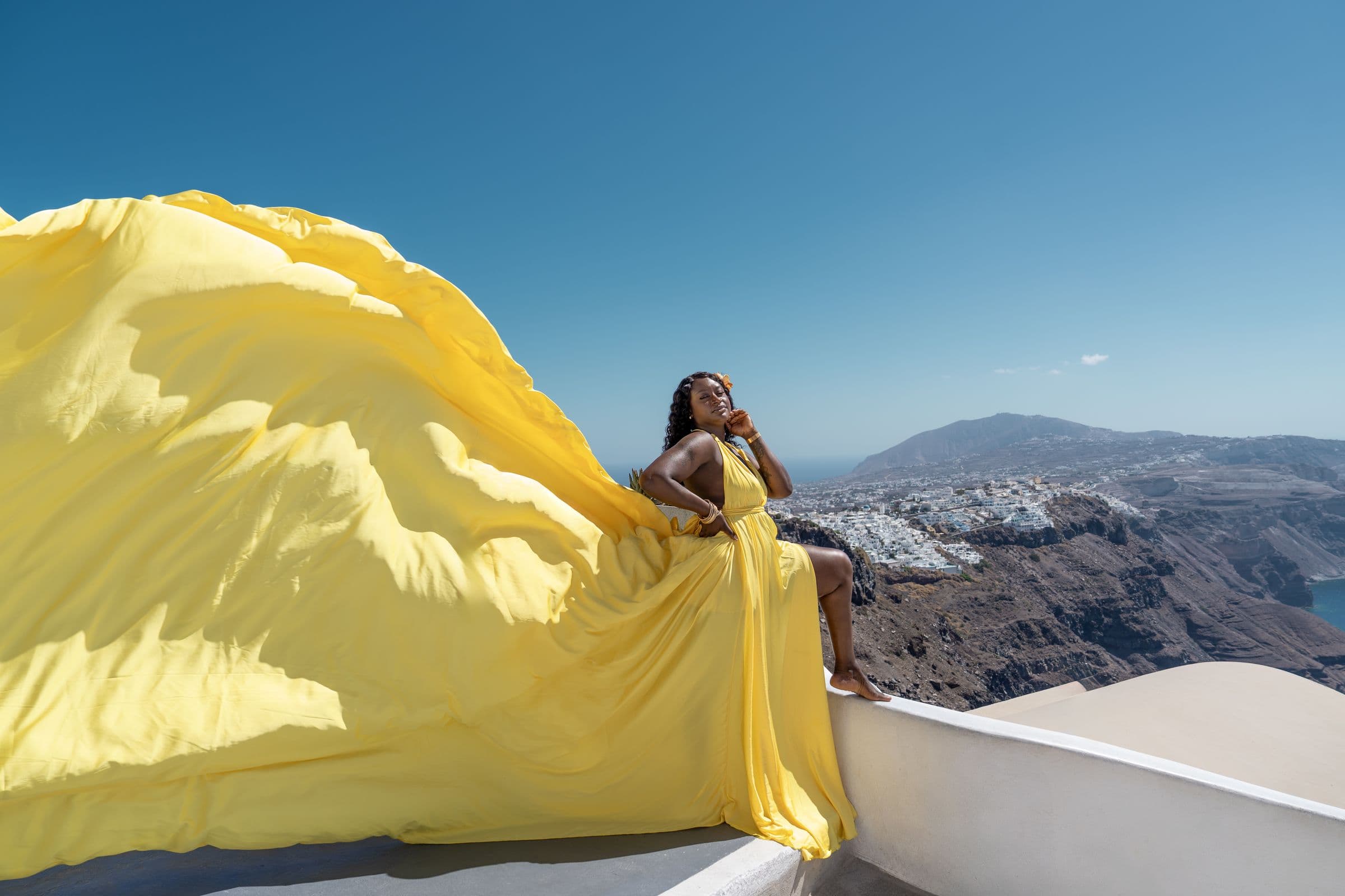 Flying dress session on Santorini cliffs
